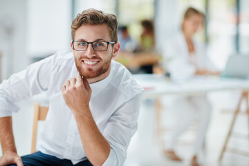 Obraz premium Portrait, smile or man in advertising agency for planning, professional or confident for branding opportunity. Happy, creative or project manager at work for digital marketing, pride or career growth
