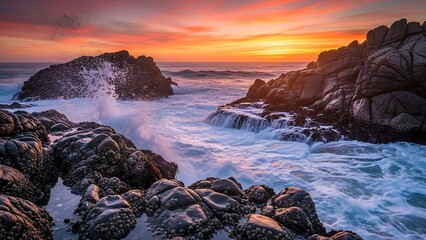 Rocky coastline at vibrant sunset hour.