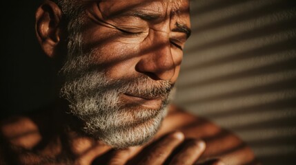 Thoughtful Man in Shadows Enjoys Quiet Moment of Reflection