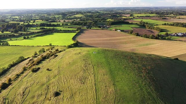 Cley Hill Camp univallate Iron Age hillfort near Warminster, Wiltshire. The 2 central Bronze Age bowl barrows seen from the south. Video fly over barrows to old quarry