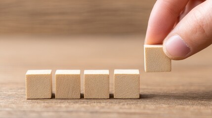 Placing wooden blocks table top photo indoor close-up precision and focus in building skills