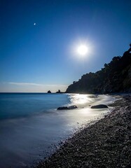 Long exposure shot of a serene beach under the moonlight