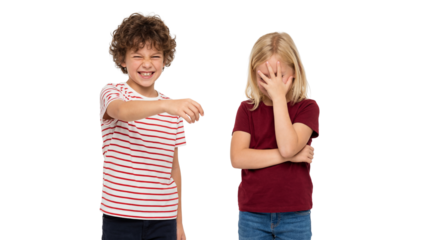 Young boy laughing and pointing at embarrassed girl covering her face