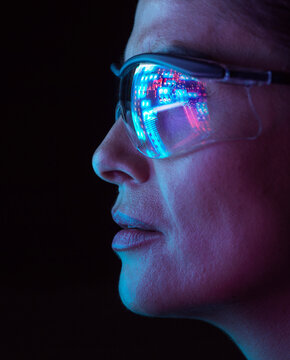 Engineer wearing smart glasses with AI chip reflection in virtual world