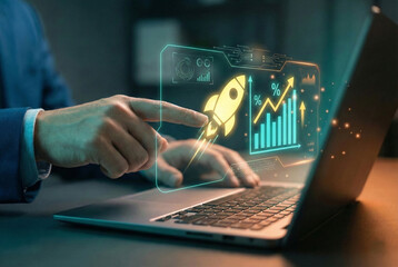 Startup business growth concept. Businessman pointing at rising bar graph with rocket icon, percentage sign and upward arrows, symbolizing success, investment return, and financial innovation.