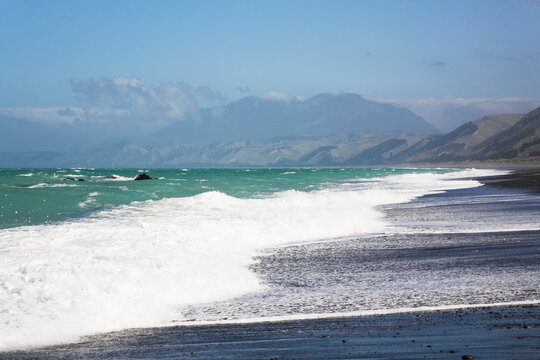 Surf on Kaikoura Coast with Kaikoura Ranges in Canterbury New Zealand