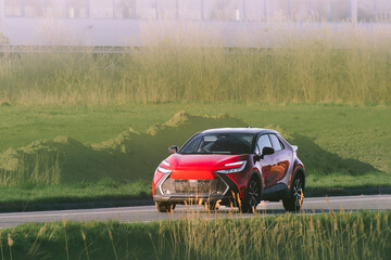 Fototapeta premium Crossover car driving in a tranquil natural area