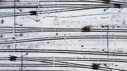 Railway lines, train tracks covered with snow aerial drone view, railway in the Netherlands in winter, transport disruption due to winter weather problems and heavy snow