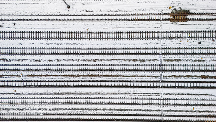 Railway lines, train tracks covered with snow aerial drone view, railway in the Netherlands in winter, transport disruption due to winter weather problems and heavy snow