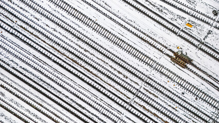 Railway lines, train tracks covered with snow aerial drone view, railway in the Netherlands in...