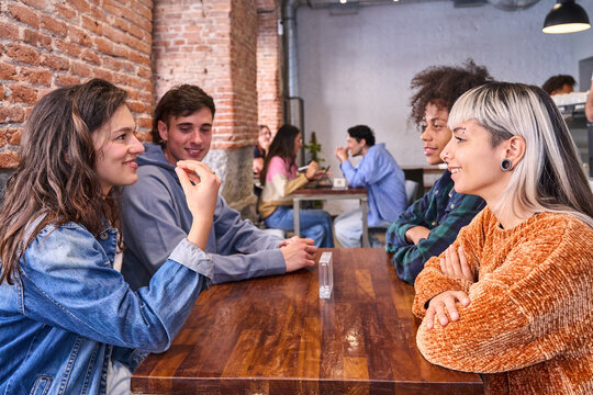 Friends having a cheerful conversation in a modern cafe