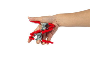 A studio shot of a red stainless spring clamp in hand isolated on a transparent background