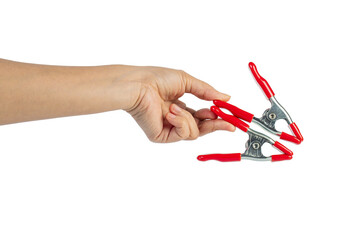 A studio shot of a red stainless spring clamp in hand isolated on a transparent background