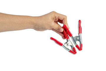 A studio shot of a red stainless spring clamp in hand isolated on a transparent background