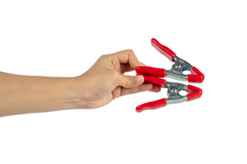 A studio shot of a red stainless spring clamp in hand isolated on a transparent background