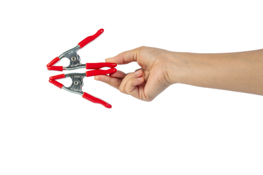 A studio shot of a red stainless spring clamp in hand isolated on a transparent background - Powered by Adobe