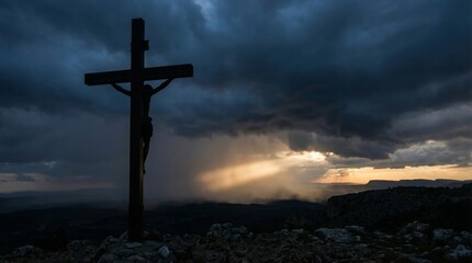 Dramatic sunset with crucifix silhouette against stormy sky for easter reflection concept