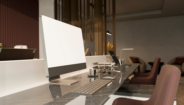 Modern office desk with blank computer monitor in contemporary workspace