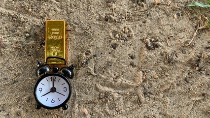 view of gold bar and clock, suitable for  financial planning or investment, photo concept