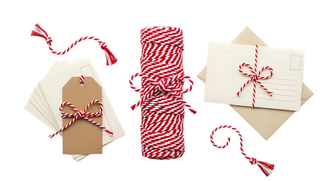 A roll of red and white striped ribbon png alongside envelopes and gift tags adorned with red bows on a white background