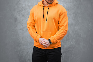 Stylish male model in vibrant hoodie and black pants © AlexGo