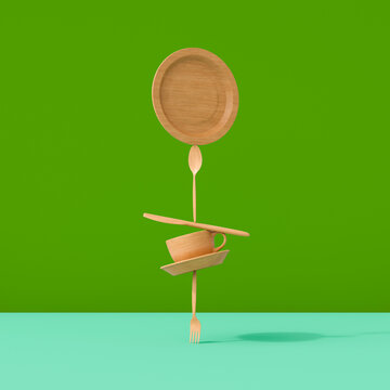 Bamboo tableware stacked in balanced composition on green background