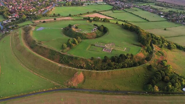 Old Sarum, Salisbury, dates from 3000 BC Neolithic. Shows Iron Age hillfort, Norman central motte and bailey and cathedral ruin. Salisbury city behind. Video fly in