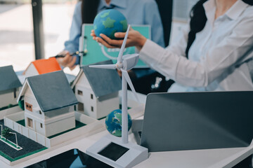 Hands of adult Asian business professionals analyzing ESG financial data and renewable energy project plans