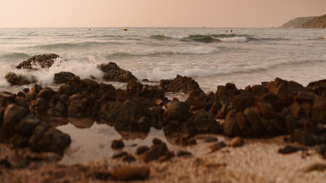 Sai kaew beach waves crashing on rocks and creating foamy water motion