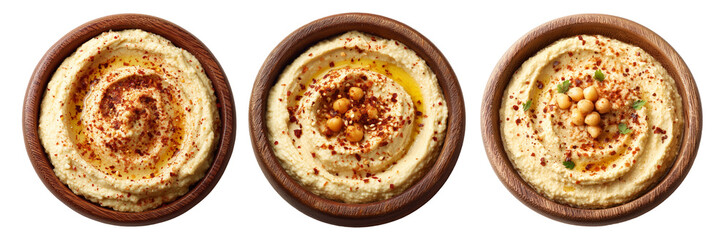 Creamy hummus garnished with olive oil, chili flakes, and mint leaves in wooden bowl, isolated on white background