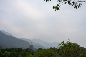 Amidst the rolling mountains stands a pagoda.