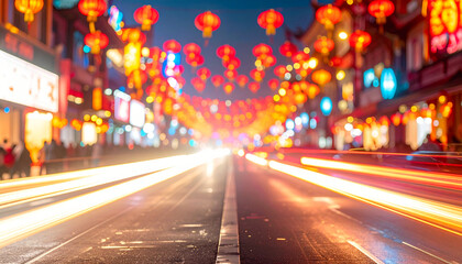 Dynamic long exposure shot of a lively city street at night, illuminated by festive red Chinese lanterns and streaks of vehicle lights, evoking the energy of an Asian festival or Chinatown.