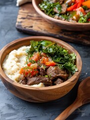 Kenyan ugali served with vegetable stew and meat showing a traditional meal in a wooden bowl on a dark table