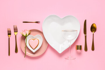 Beautiful table setting for Valentine's Day with tasty cookie and rose flower on pink background