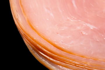 Sliced smoked beef meat in vacuum package isolated on black background. Raw smoked packaged meet isolated