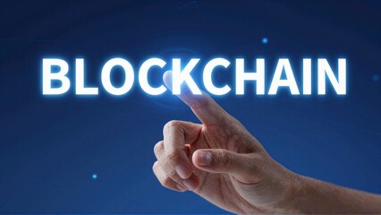 Hand pointing at blockchain on blue background