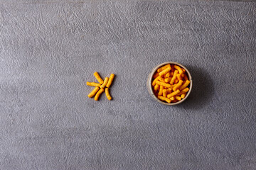 Assorted snacks in pottery bowls on grey background