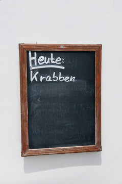 Blackboard menu with Heute Krabben text outdoors in Amrum Germany