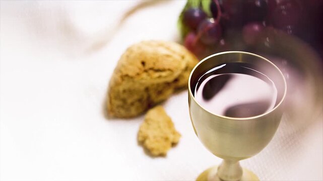 Holy Communion bread and wine, wine background with ripples in the wine cup of the Last Supper of Jesus Christ
