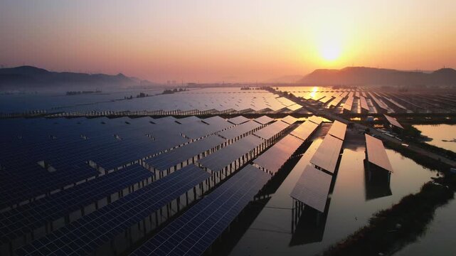 Solar power plant at sunset with stunning reflections on water surface