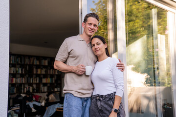 Parents relaxing together at home with coffee cup in comfortable setting