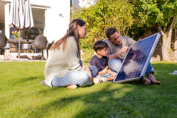 Family learning about solar panel and sustainable energy outdoors at home