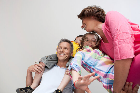 Happy family enjoying playful moment together indoors from below
