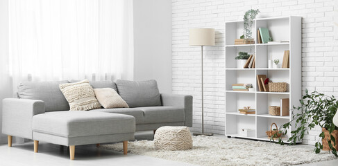 Interior of living room with bookshelf, sofa and plants © Pixel-Shot