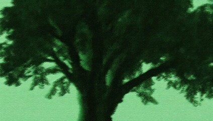 Fototapeta premium Silhouette of a tree against a green background, creating a serene atmosphere.