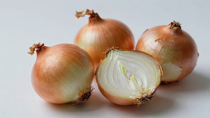 Sliced and whole yellow onions on white background