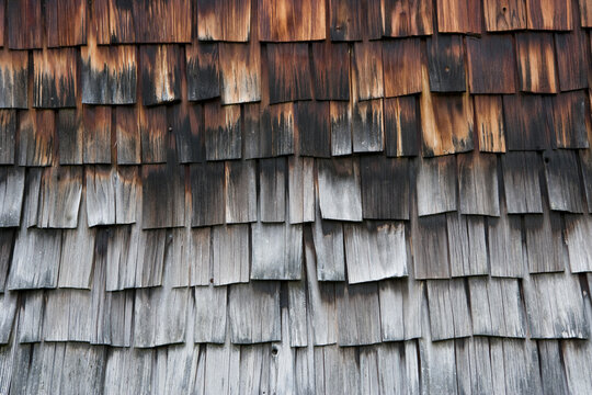 Weathered wooden shingle facade detail on farmhouse in Stuebing Styria