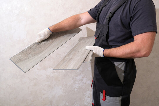 Handyman installing vinyl planks for flooring renovation project
