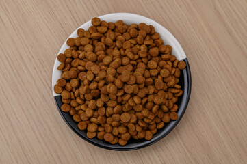 Dry cat food in a bowl, cereal crisps