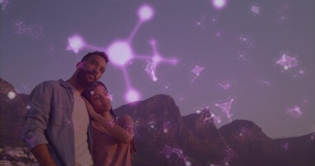 Fototapeta premium Standing pair leaning on shoulder looking over peaks at dusk denim-shirt purple-overlay, copy space